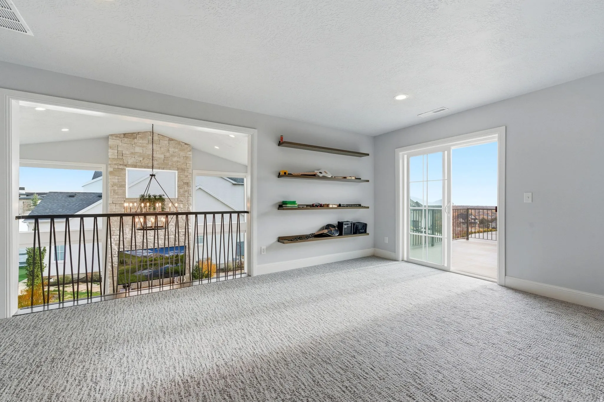 Carpeted spare room featuring a chandelier, vaulted ceiling, a textured ceiling, and recessed lighting