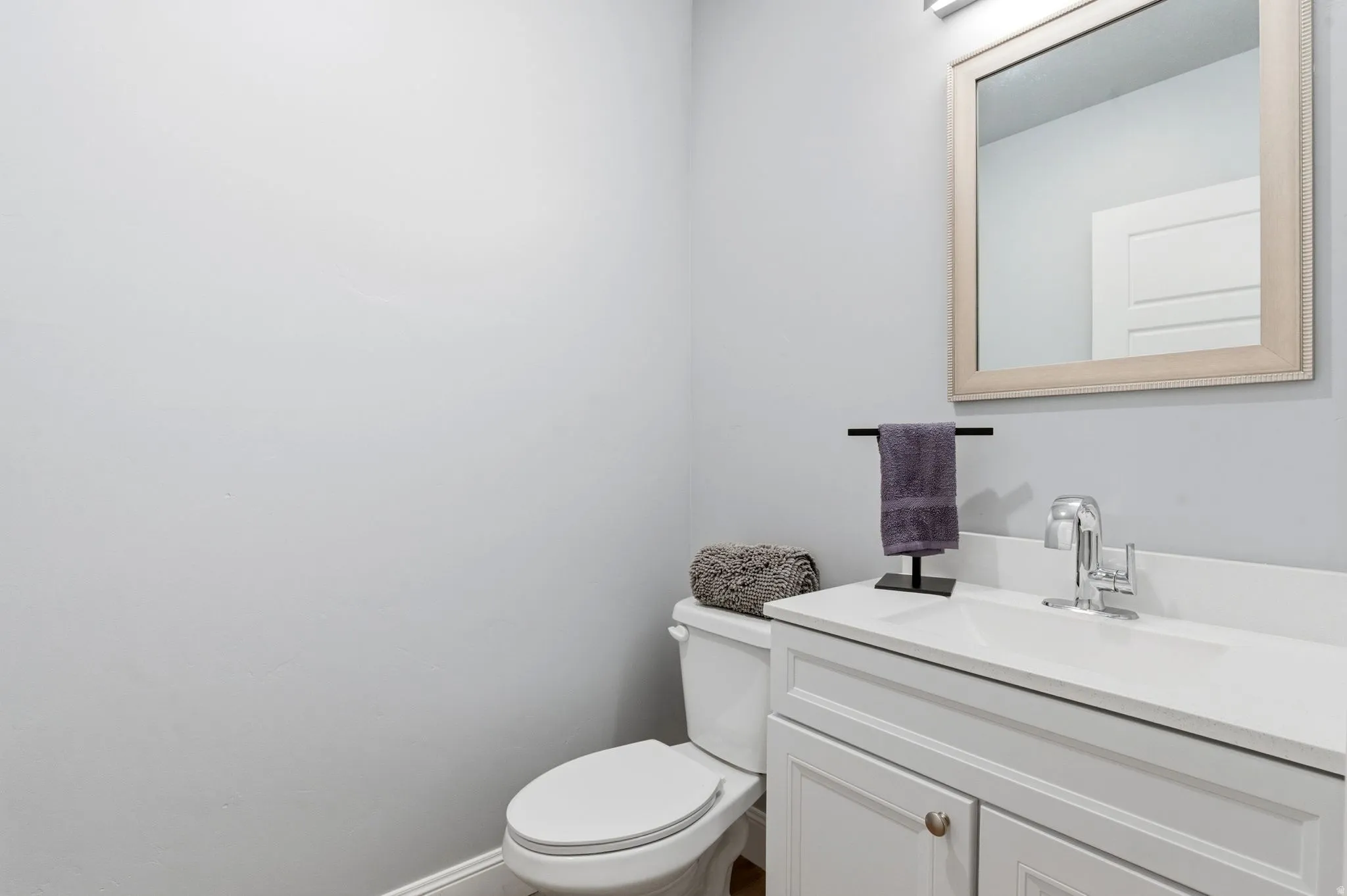 Half bath featuring vanity and toilet