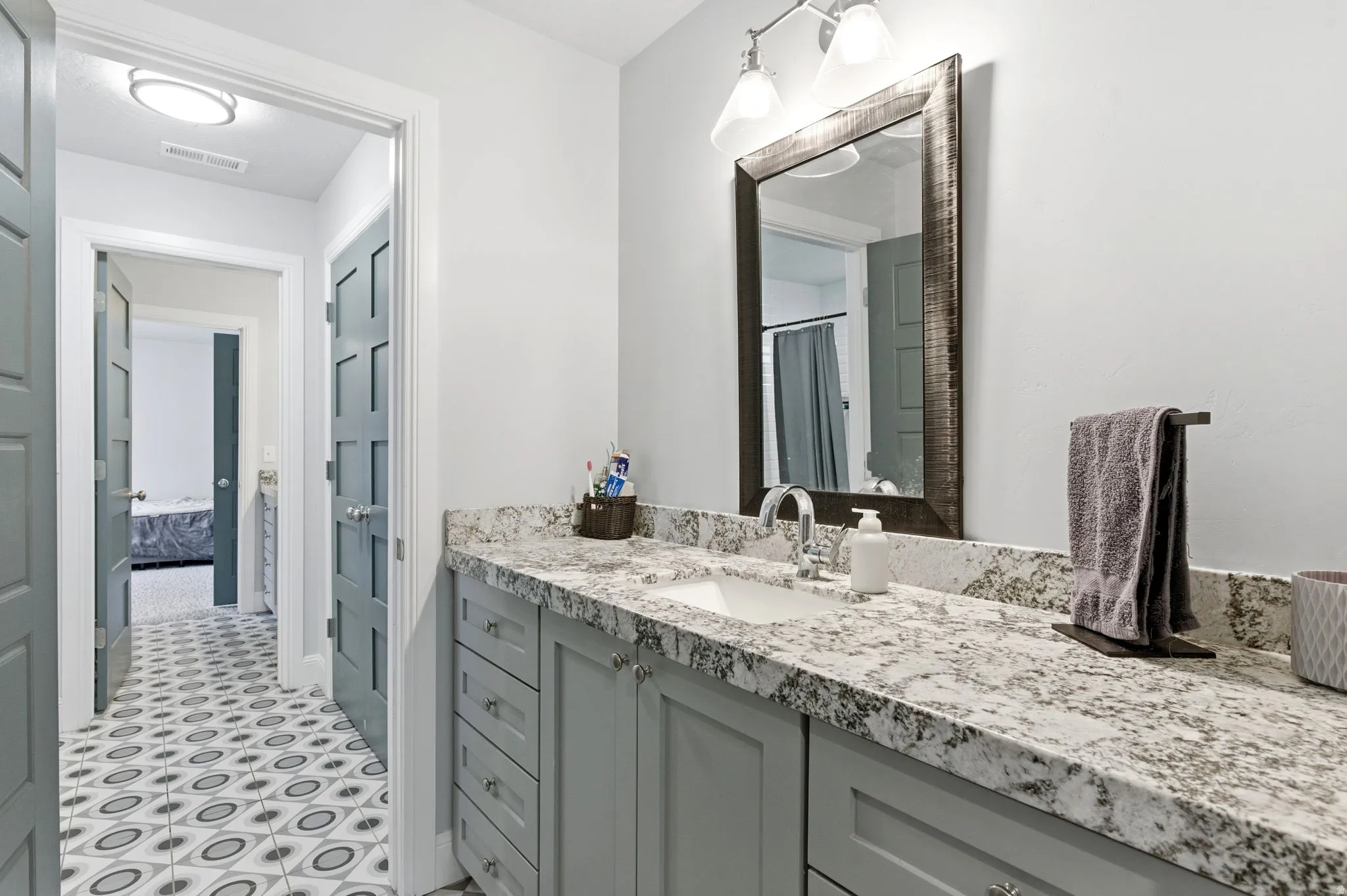 Ensuite bathroom featuring vanity and a shower with shower curtain