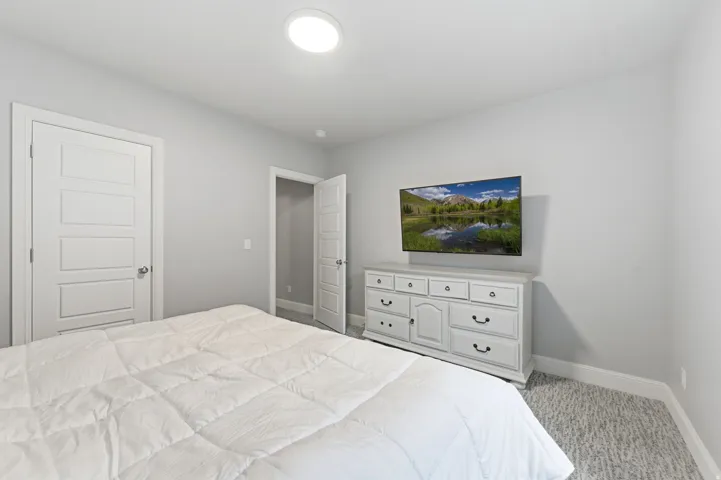 Bedroom featuring baseboards and carpet floors