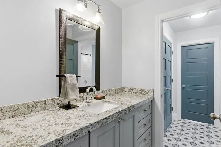 Full bath with vanity and a shower