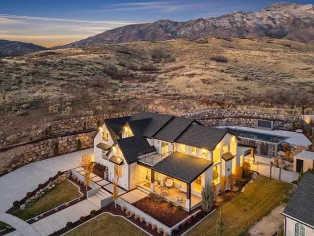 Aerial view of property and surrounding area with a mountain backdrop