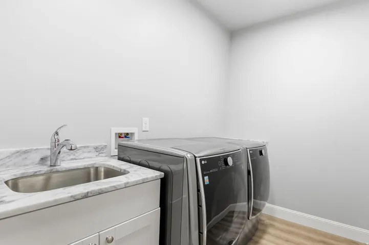 Laundry area featuring light wood-type flooring and separate washer and dryer