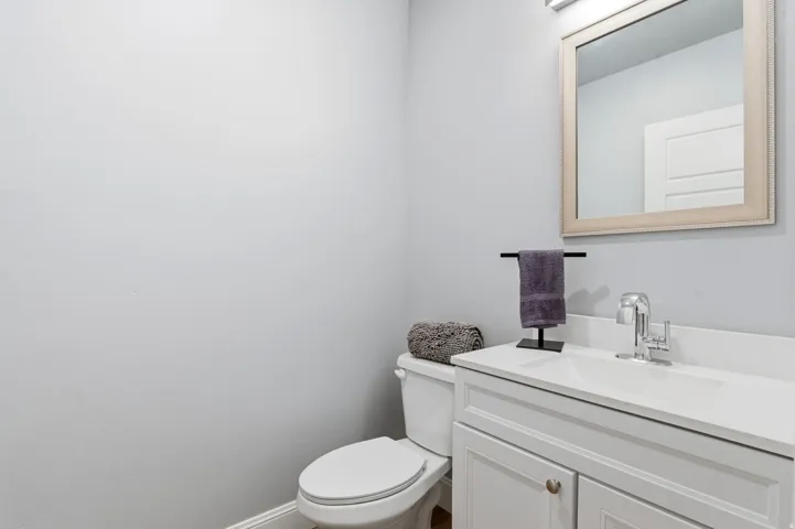 Half bath featuring vanity and toilet