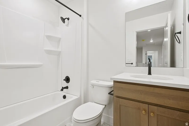 Bathroom featuring  shower combination and vanity