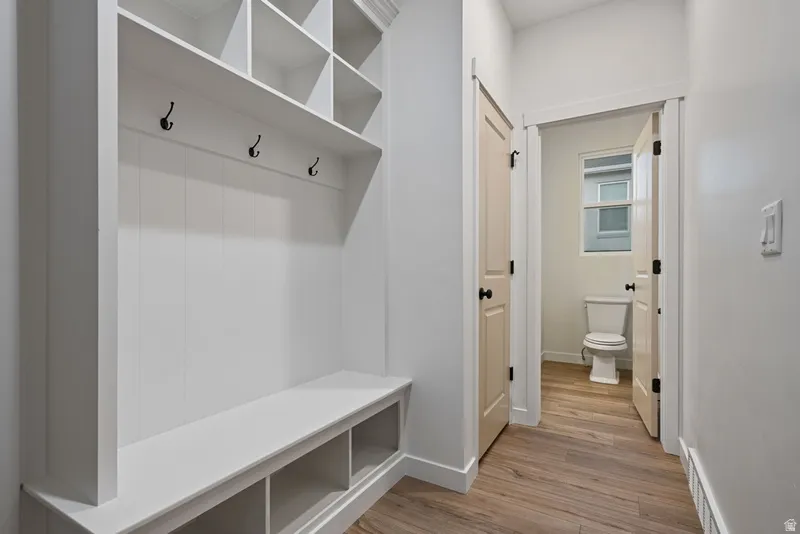 Mudroom featuring light wood-type flooring and baseboards
