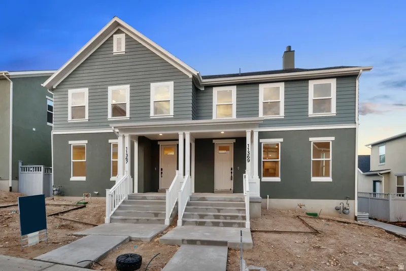 Traditional-style home with a porch and a chimney