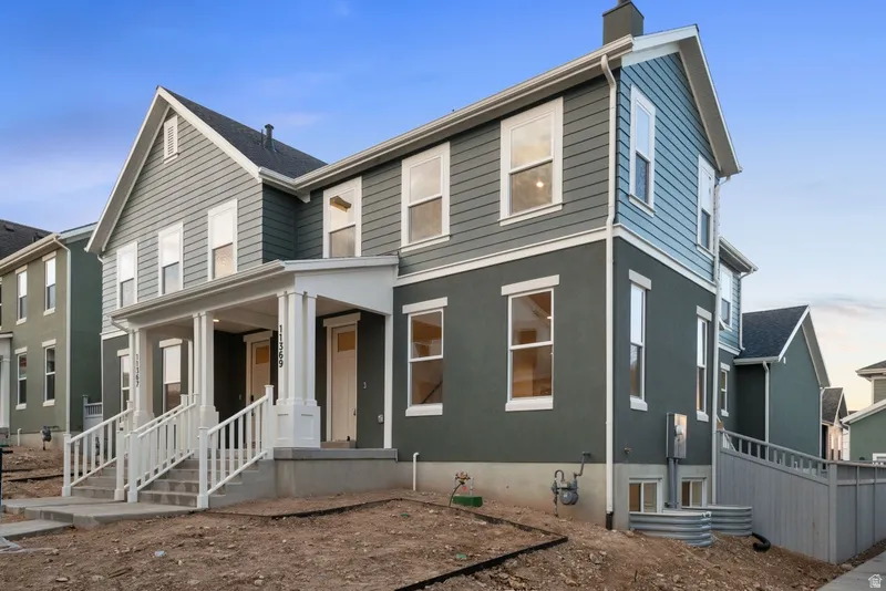 View of front of home with covered porch and a chimney