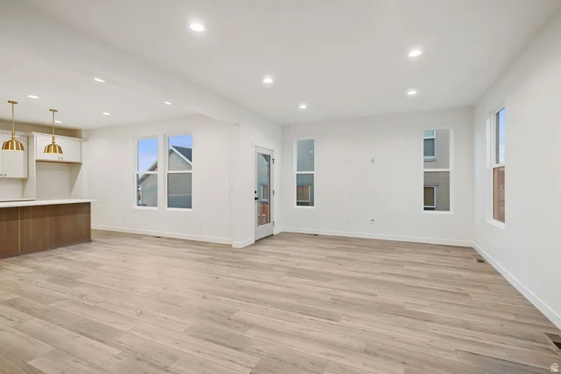 Unfurnished living room with recessed lighting and light wood-type flooring