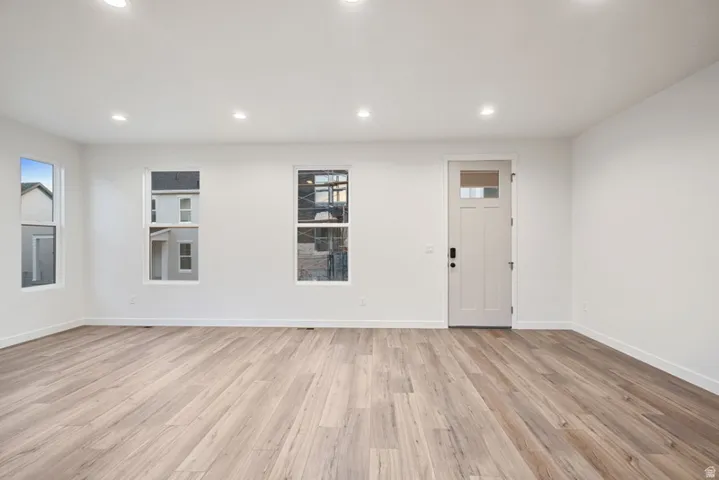 Foyer entrance with light wood-style flooring and recessed lighting