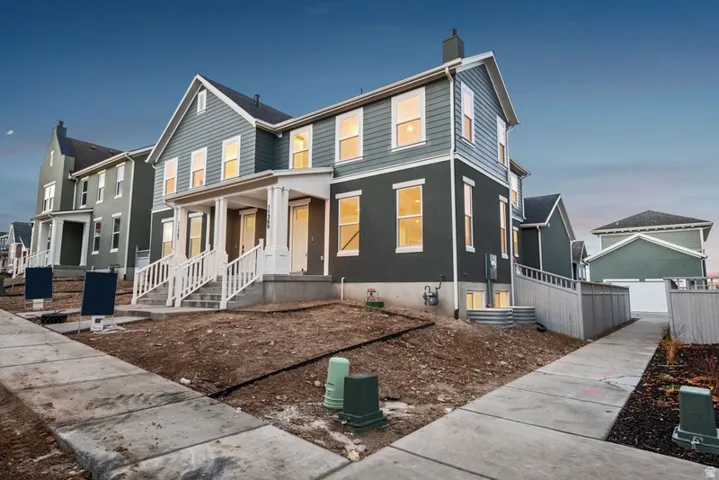Traditional home featuring a chimney, a residential view, a porch, and a garage