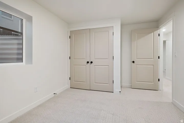 Unfurnished bedroom with carpet floors and a closet