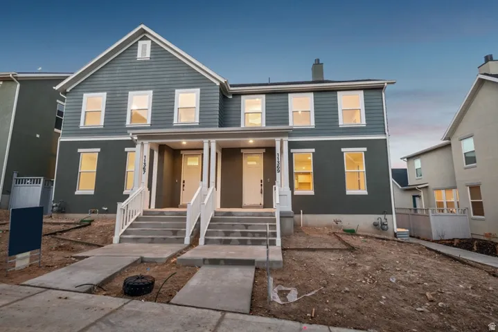 Traditional home featuring covered porch and a chimney