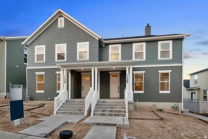 Traditional-style home with a porch and a chimney