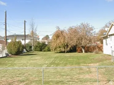 Fenced backyard with a garage
