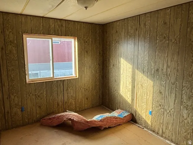 Unfurnished room with wooden walls