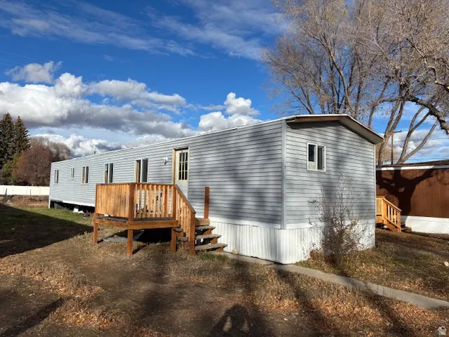 Rear view of property featuring a wooden deck