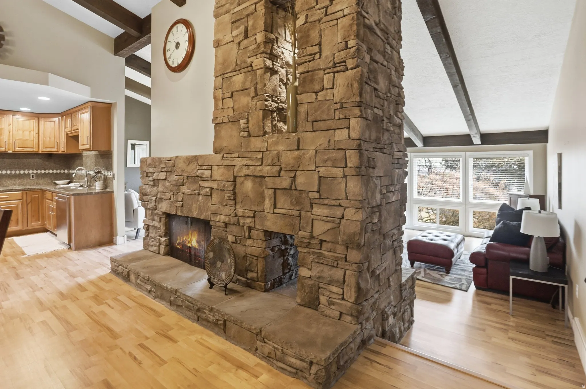 Living room with light wood-style flooring and a fireplace