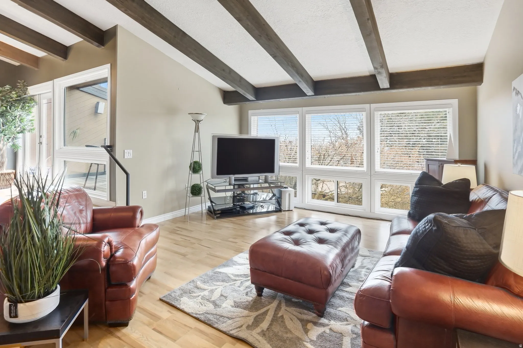 Living area with wood finished floors and healthy amount of natural light