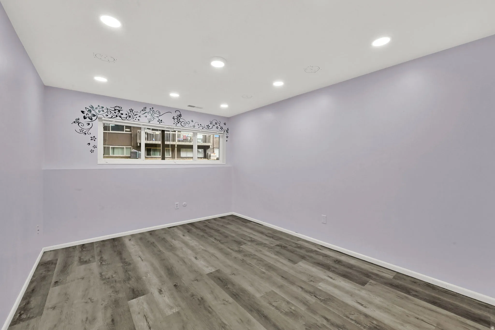 Unfurnished room featuring recessed lighting and wood finished floors
