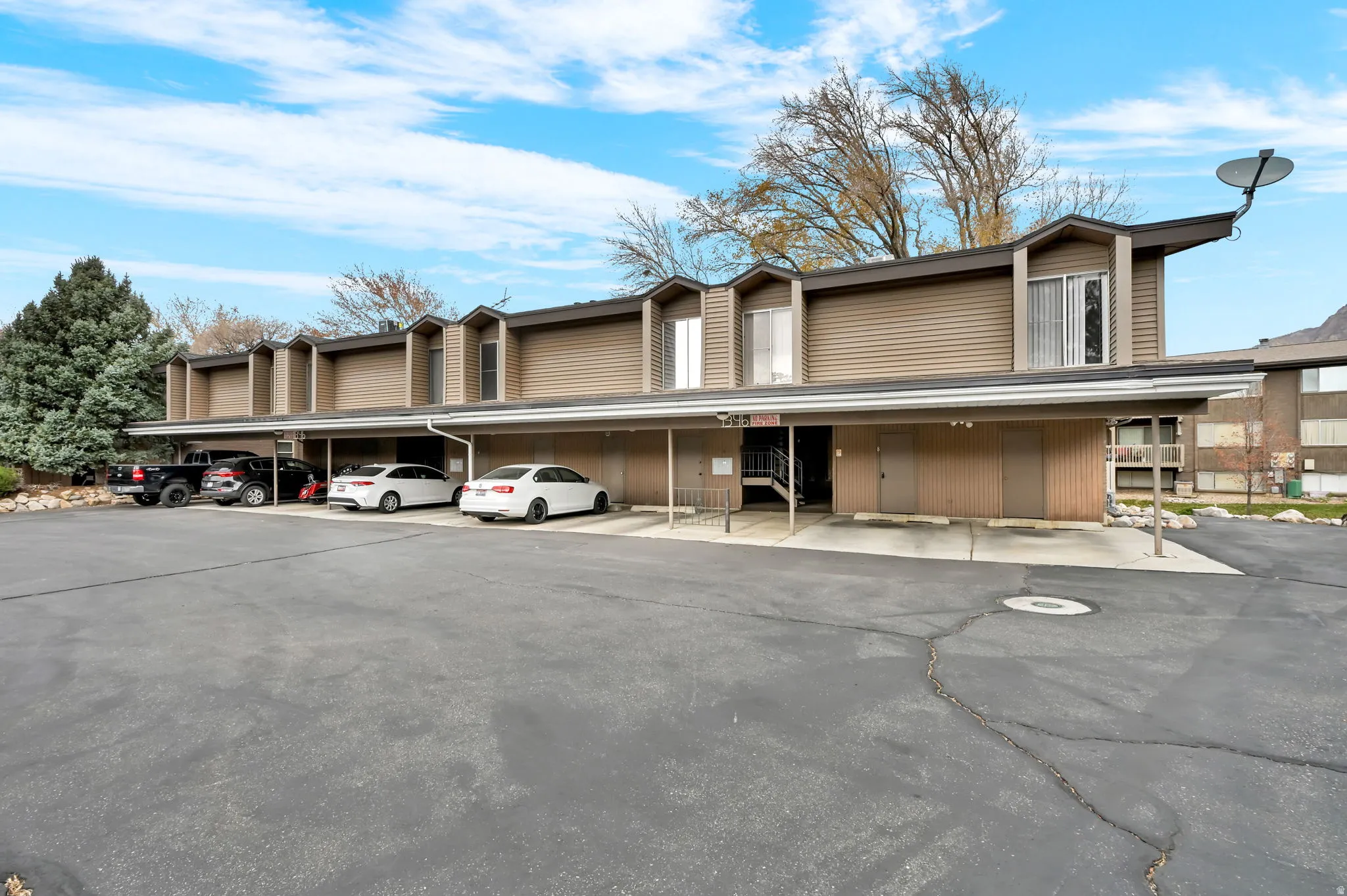View of property with covered parking