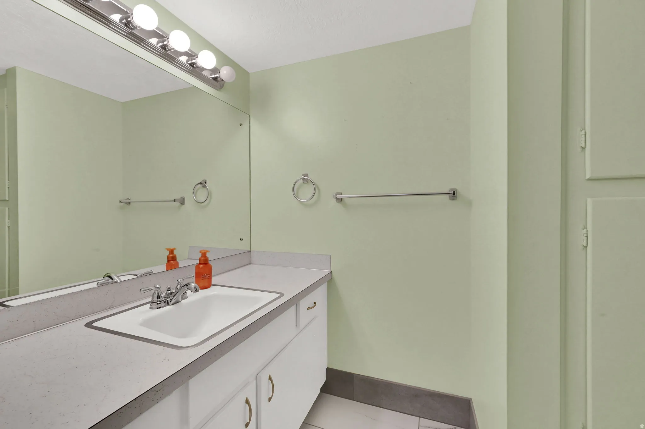 Bathroom featuring vanity and light tile patterned floors