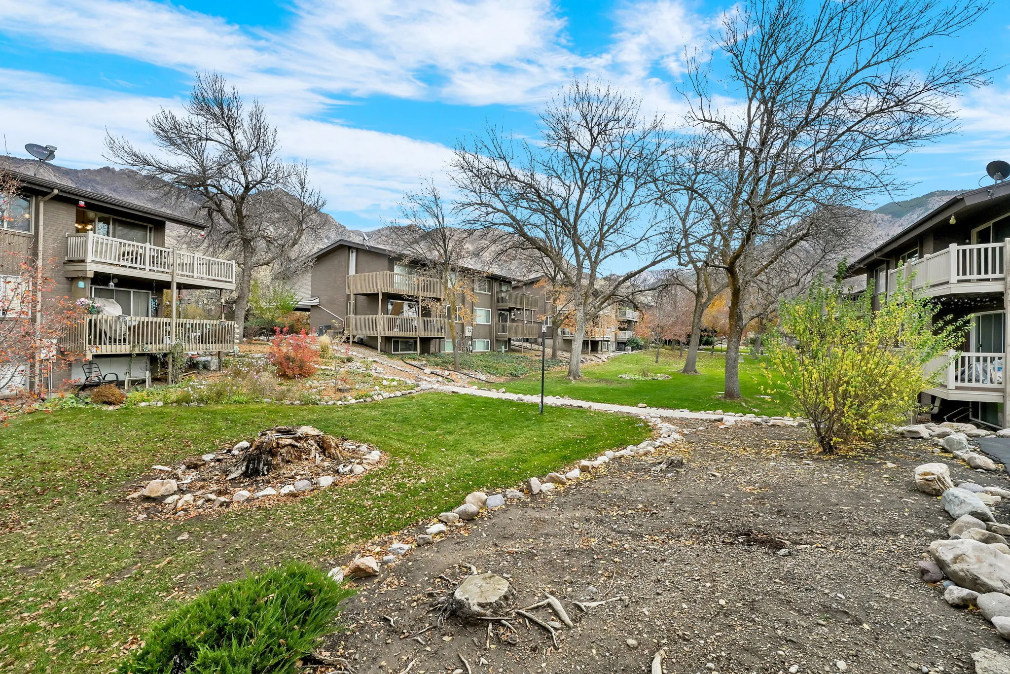 View of community featuring a yard, a residential view, and a balcony