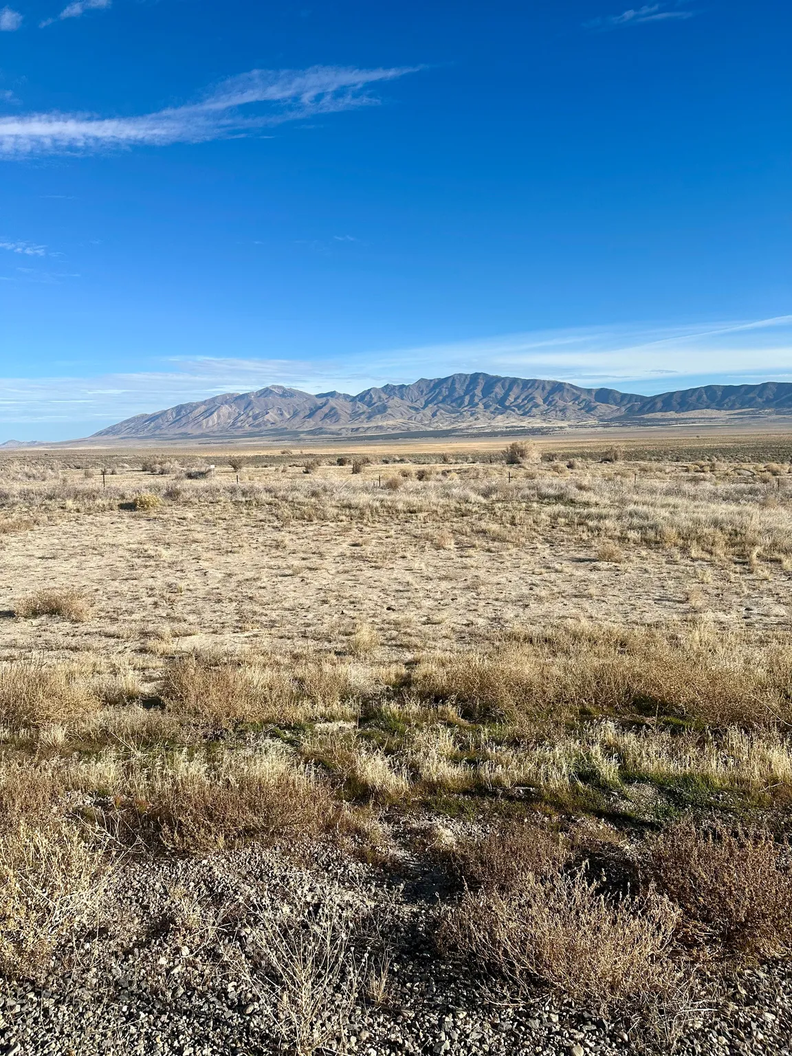 View of mountain backdrop featuring rural landscape
