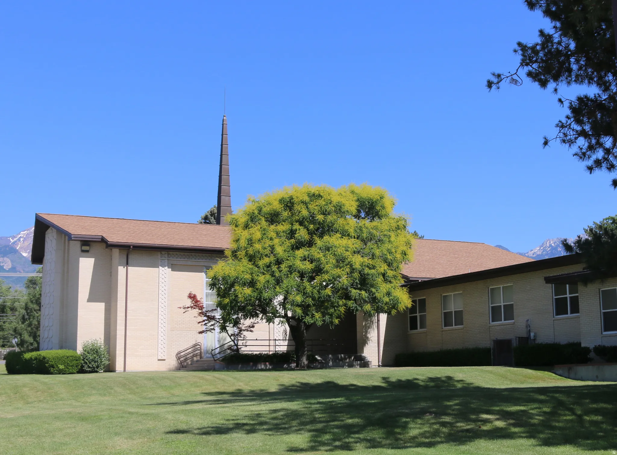 Street view of structure on property with groomed lawn