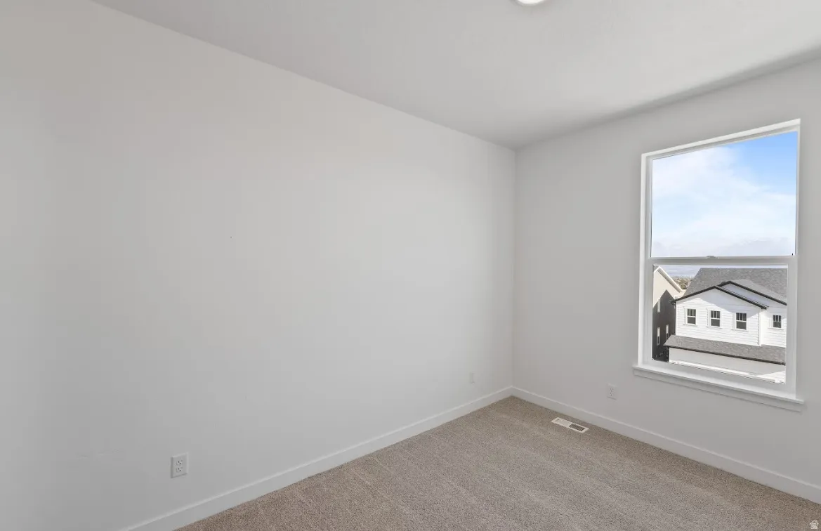 Unfurnished room with carpet floors and baseboards