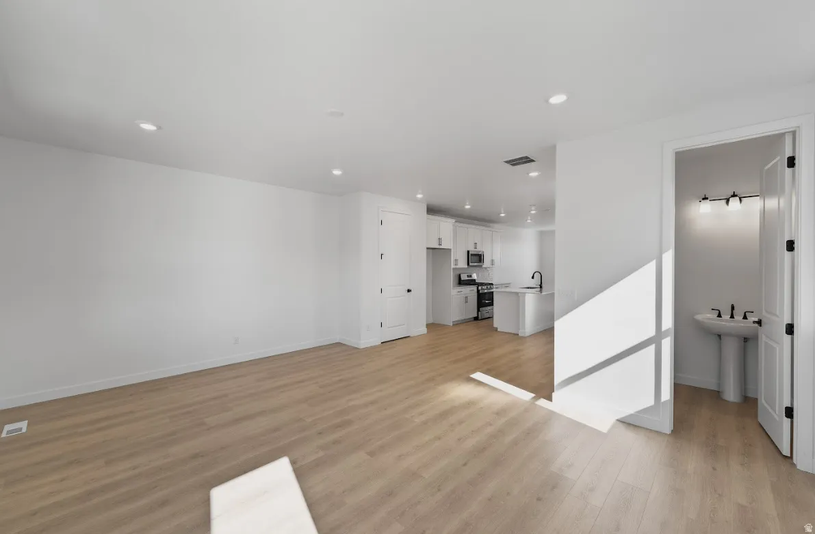 Unfurnished living room with light wood-style flooring and recessed lighting