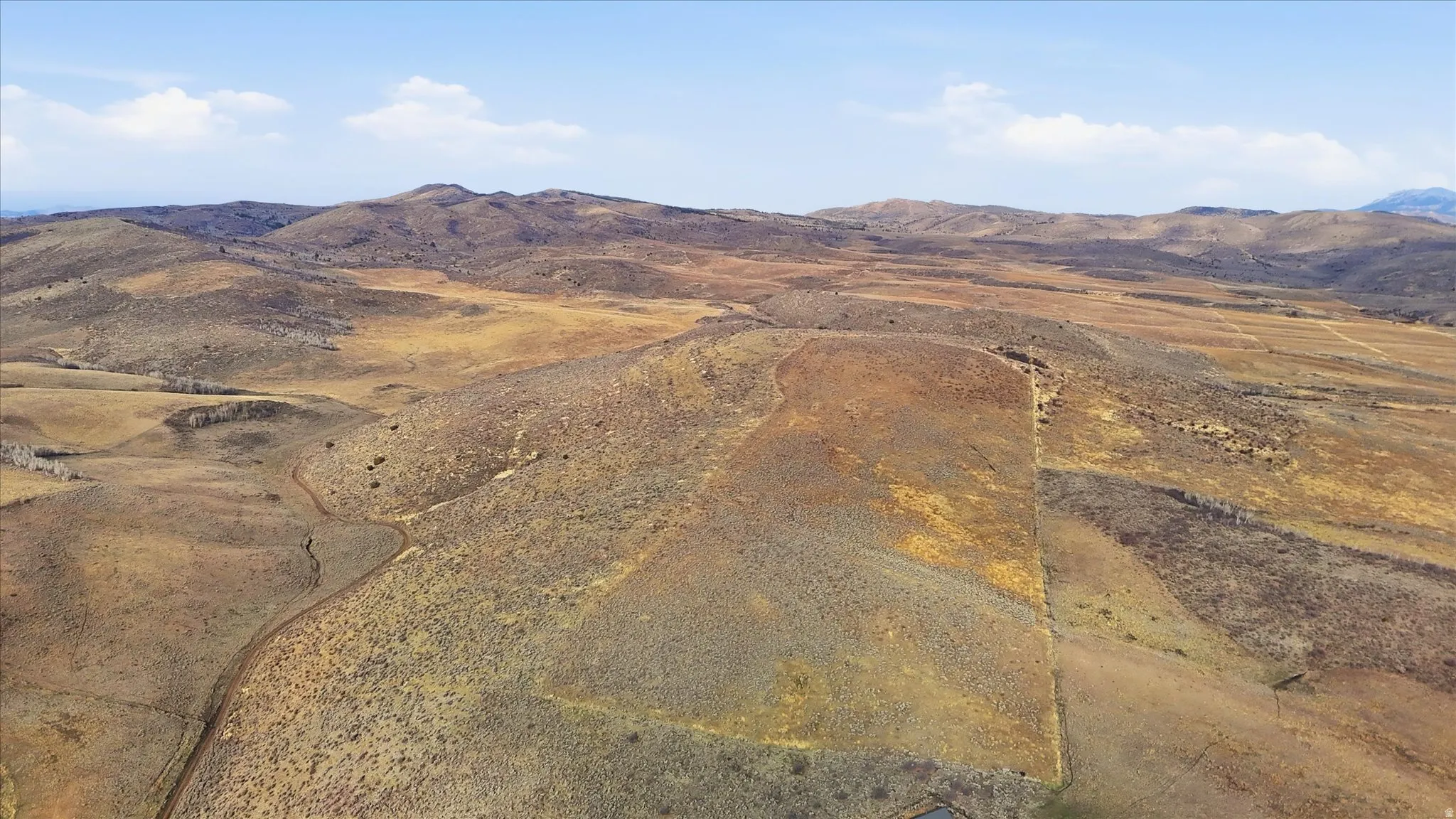View of mountain backdrop with rural landscape