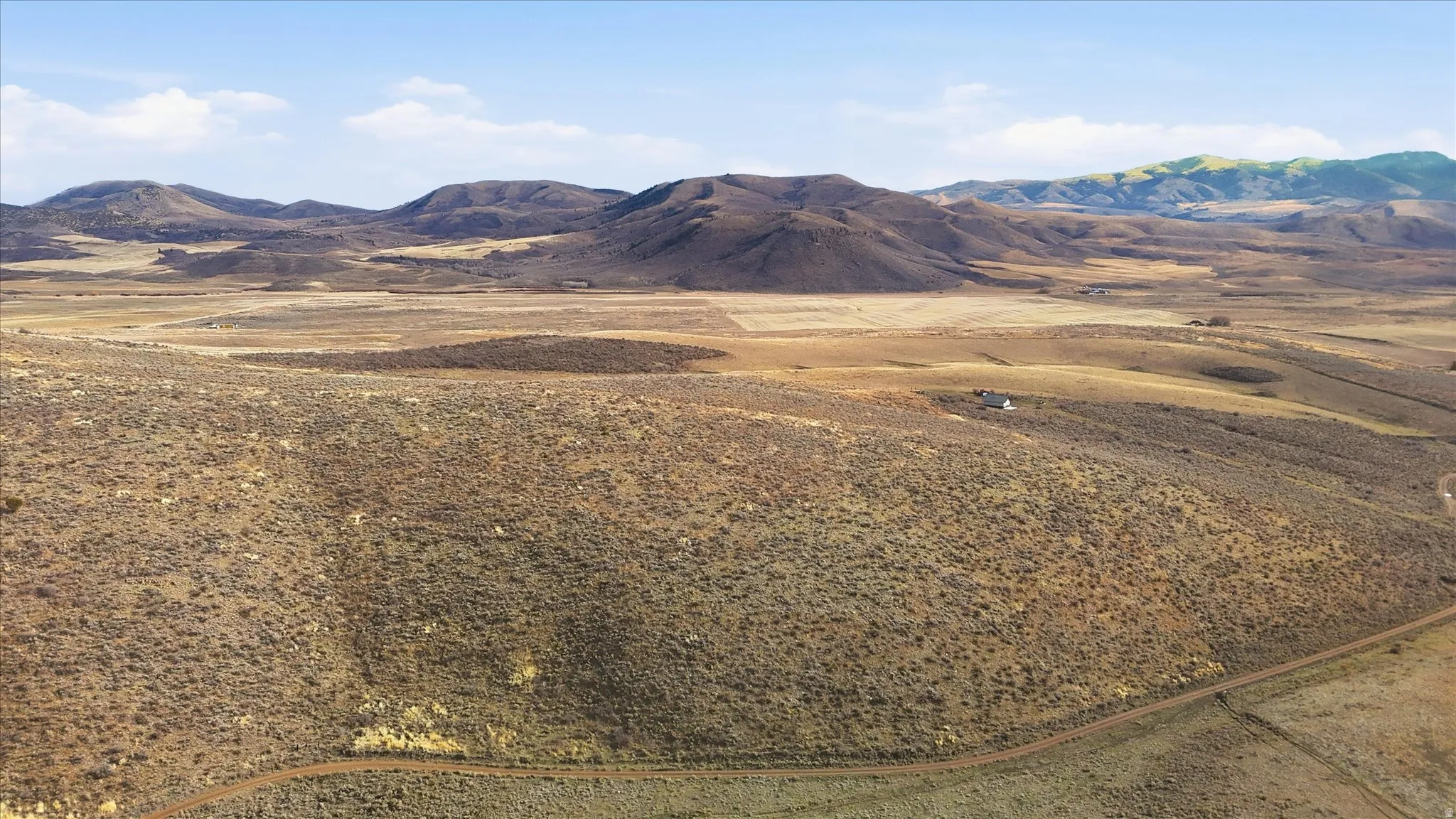 View of mountain backdrop featuring rural landscape
