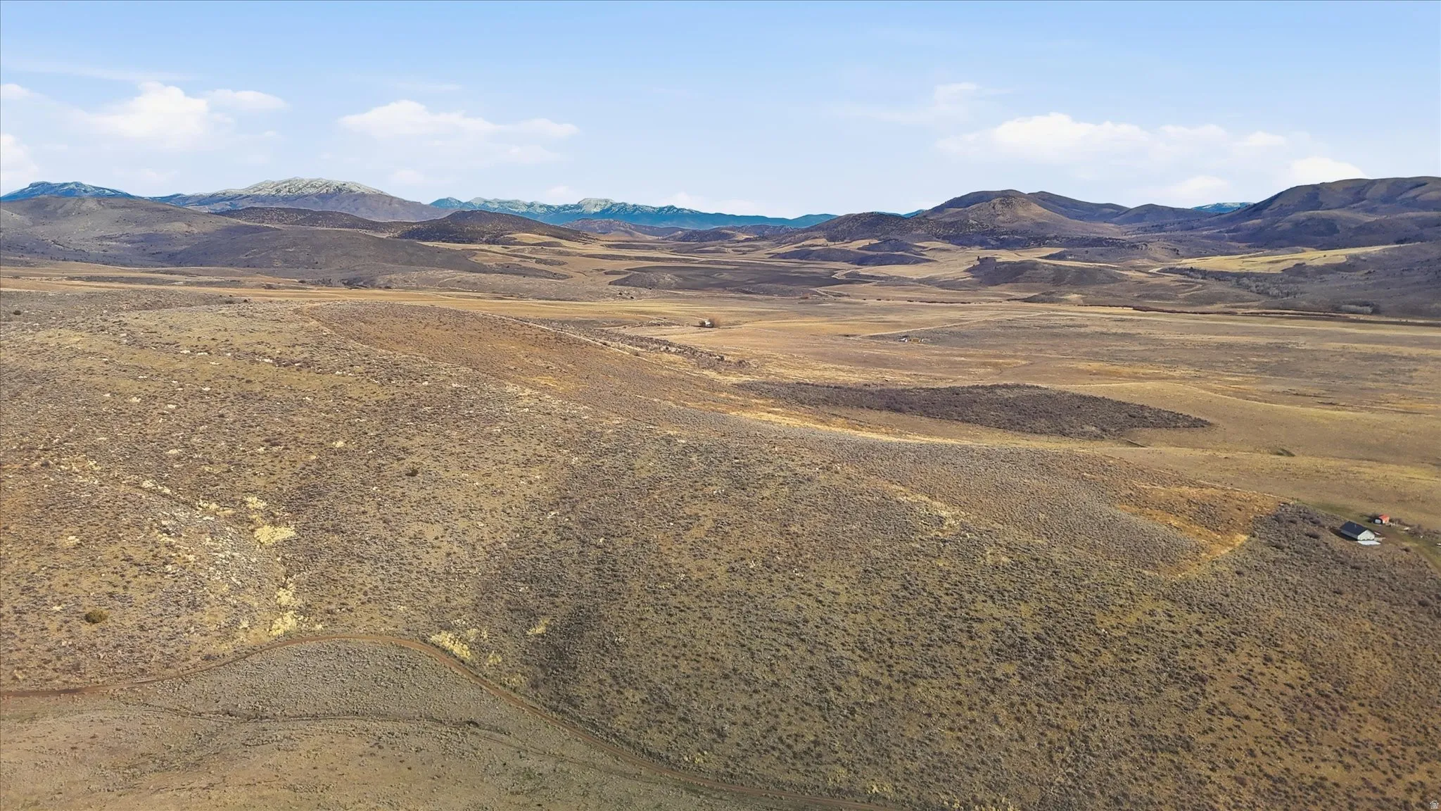 View of mountain backdrop with rural landscape