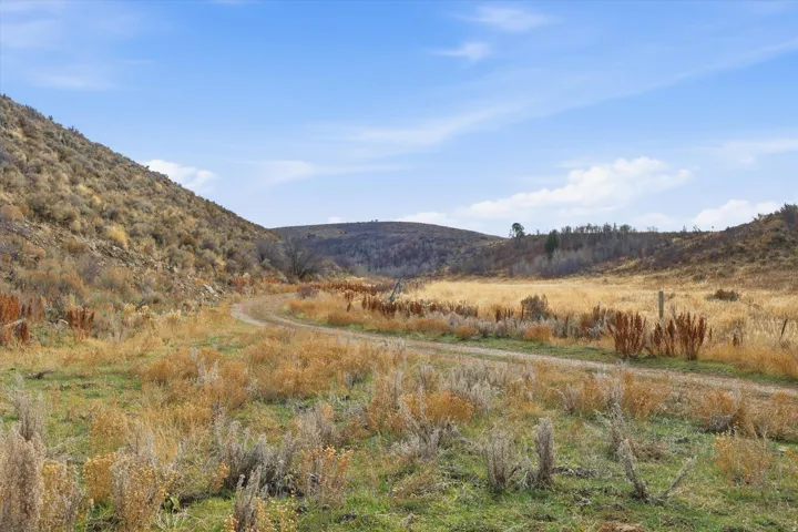 View of mountain backdrop with rural landscape