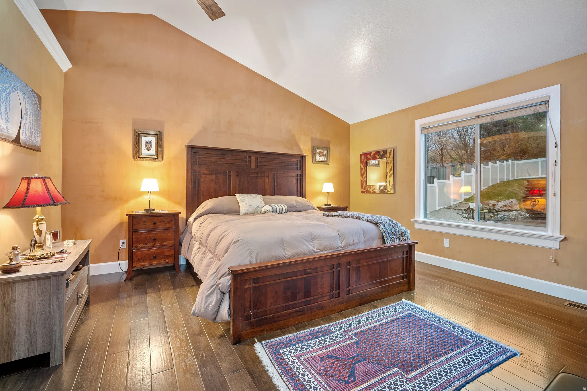 Bedroom featuring lofted ceiling, dark wood finished floors, and ceiling fan