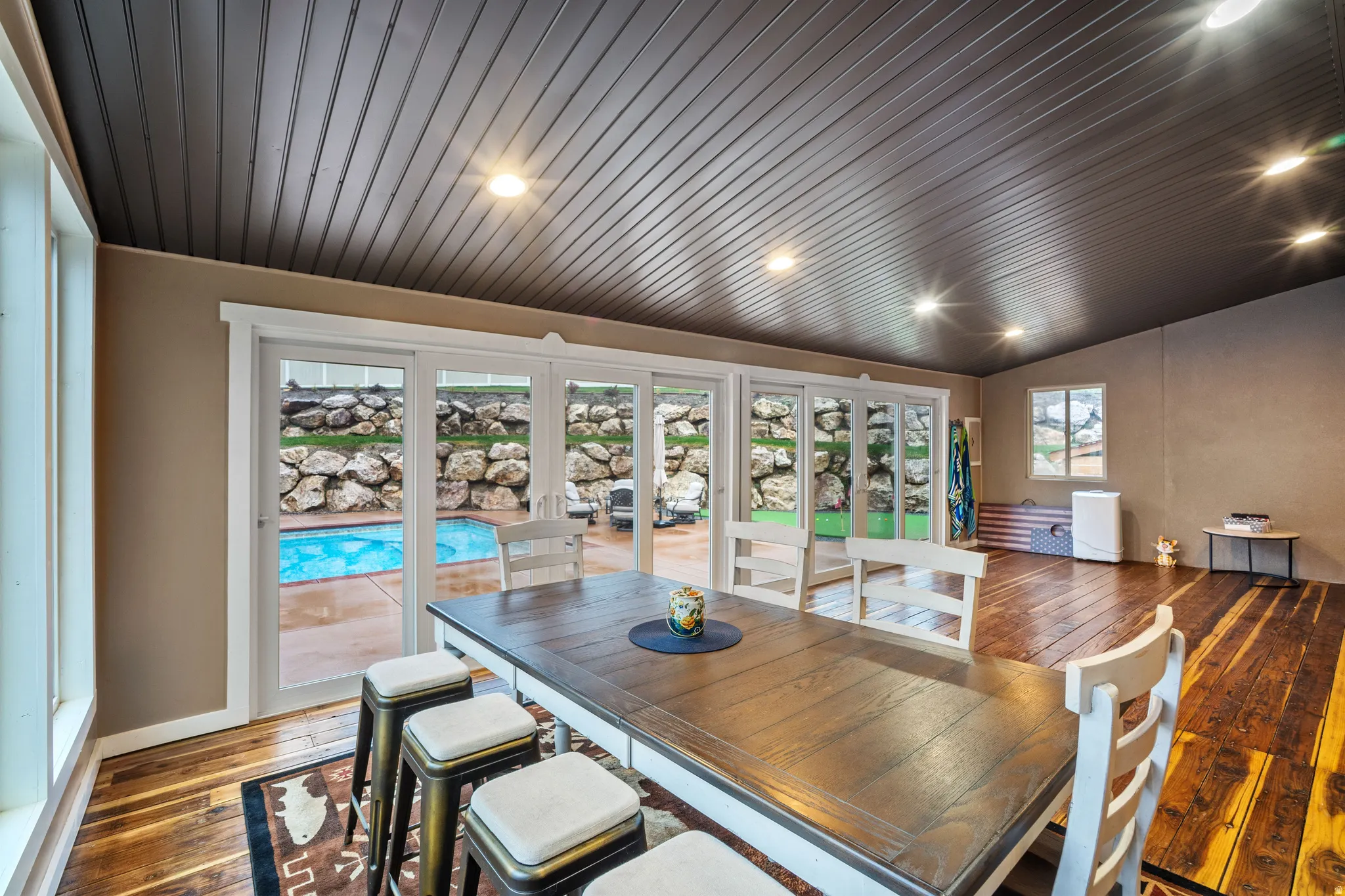 Dining room with dark wood-style flooring and vaulted ceiling