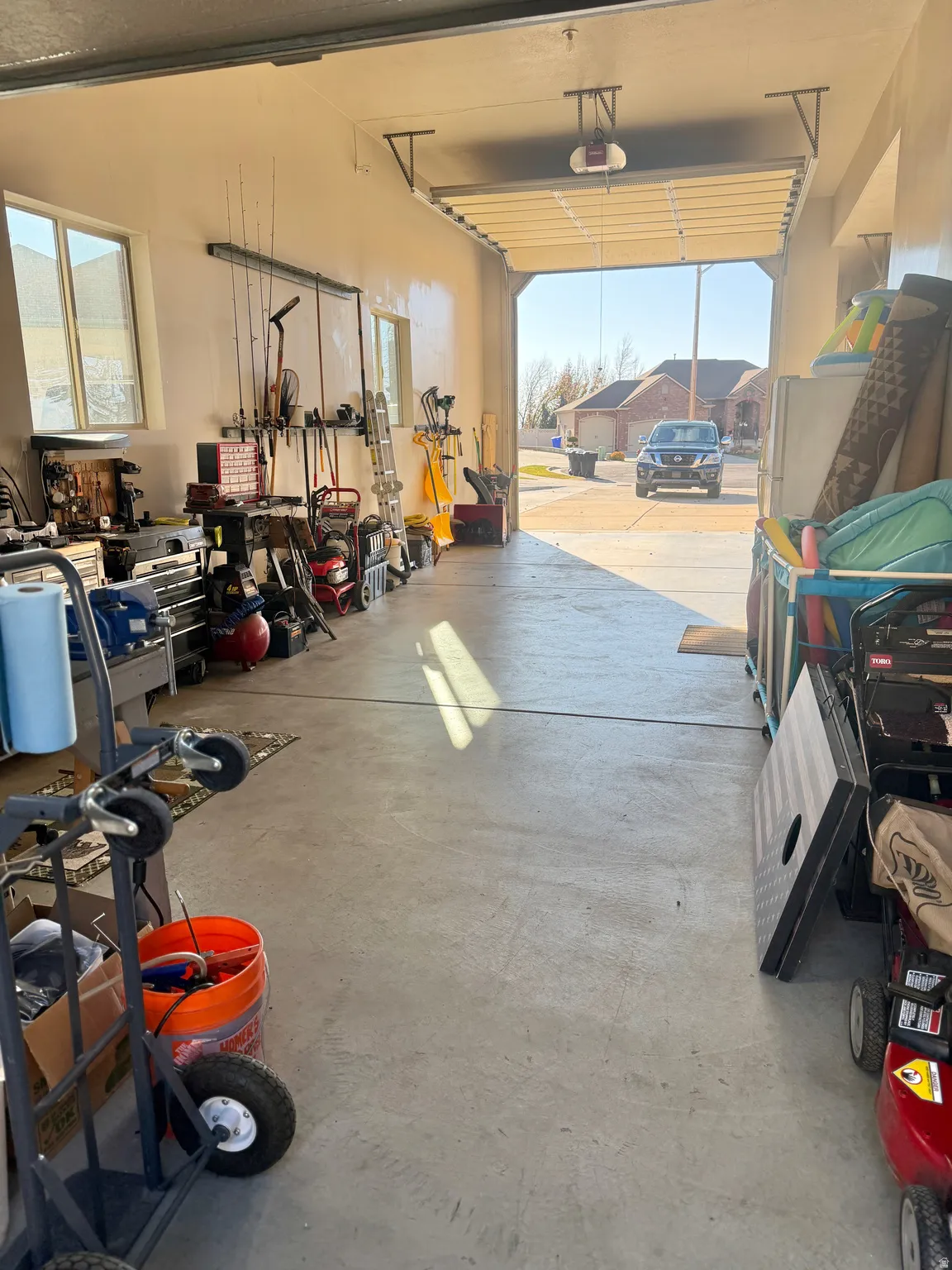 Garage with a workshop area and freestanding refrigerator