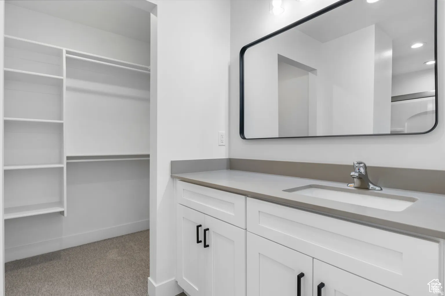 Full bathroom with light colored carpet, vanity, and recessed lighting