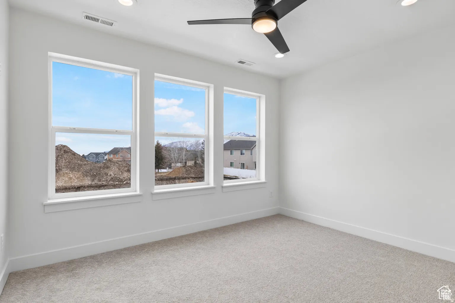 Unfurnished room featuring light carpet, ceiling fan, and recessed lighting
