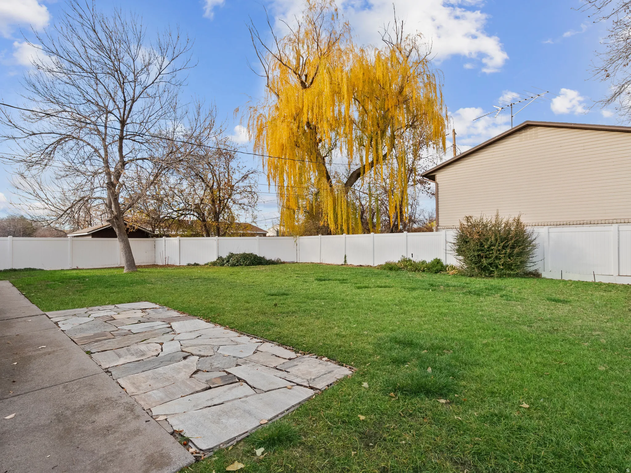 Fenced backyard with a patio