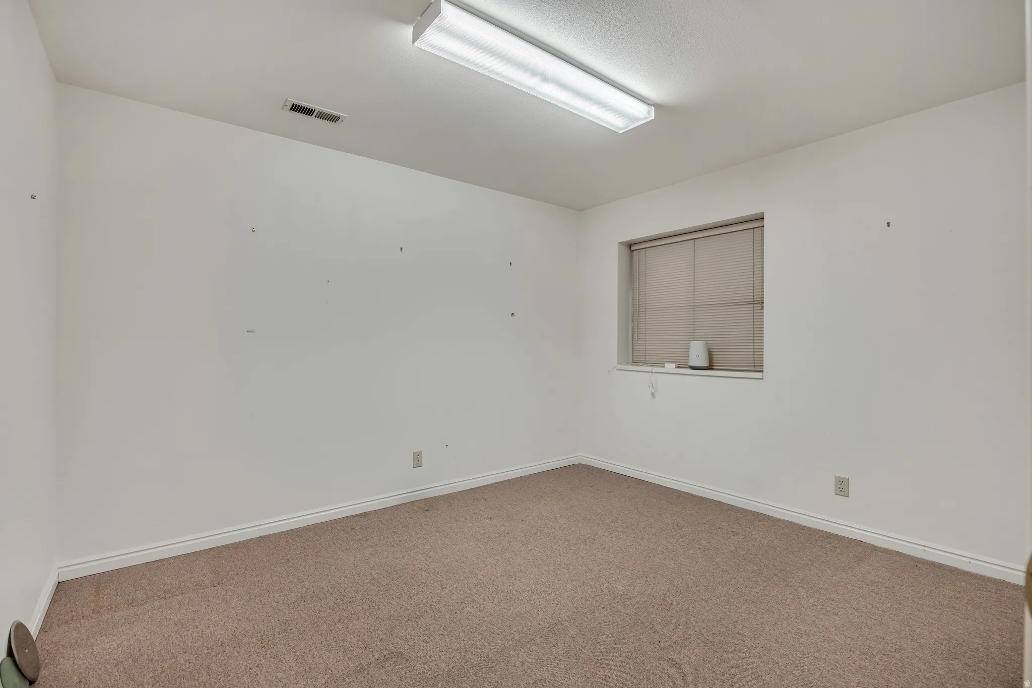 Spare room with carpet and baseboards