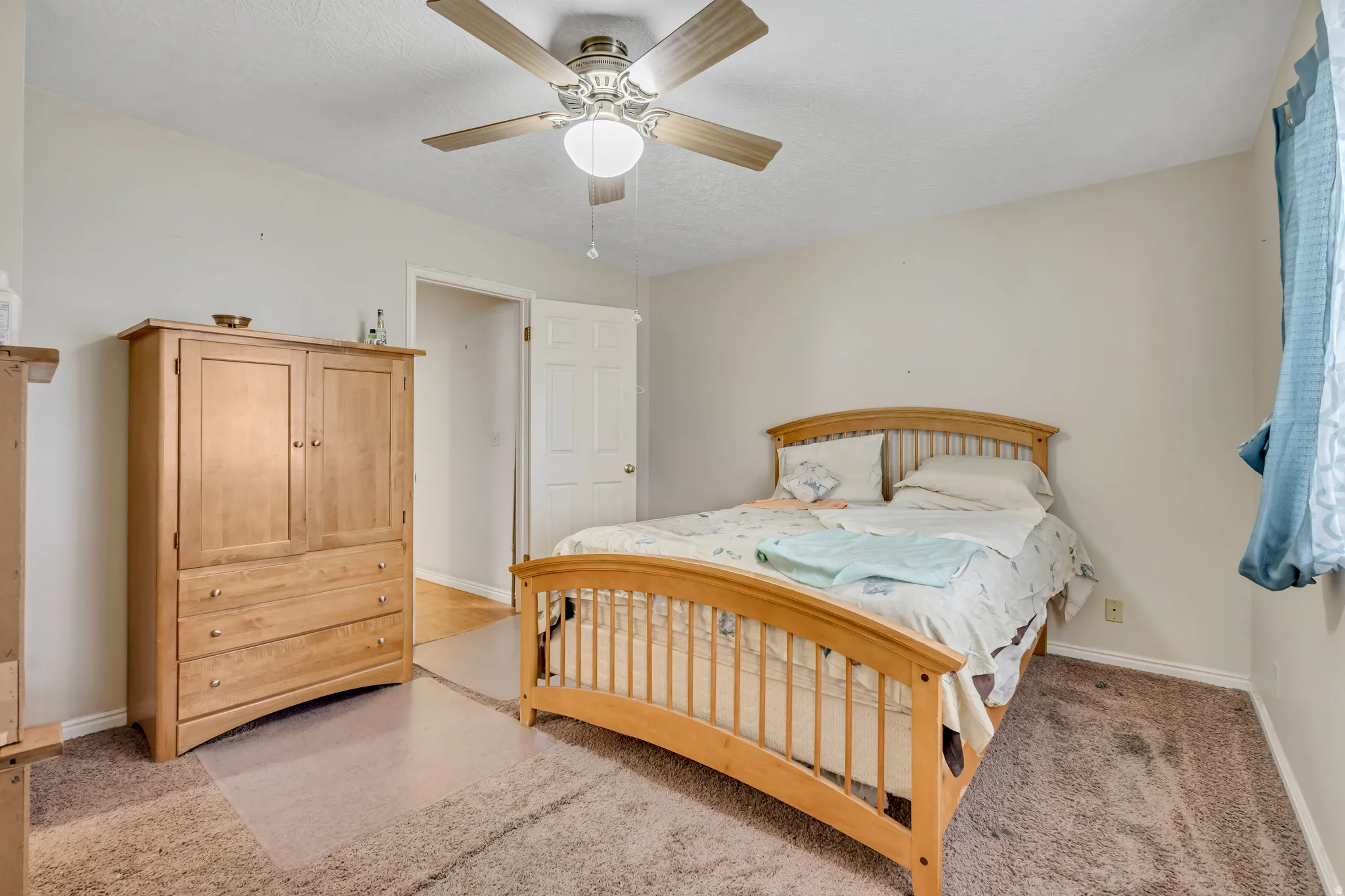 Bedroom featuring a ceiling fan and light colored carpet