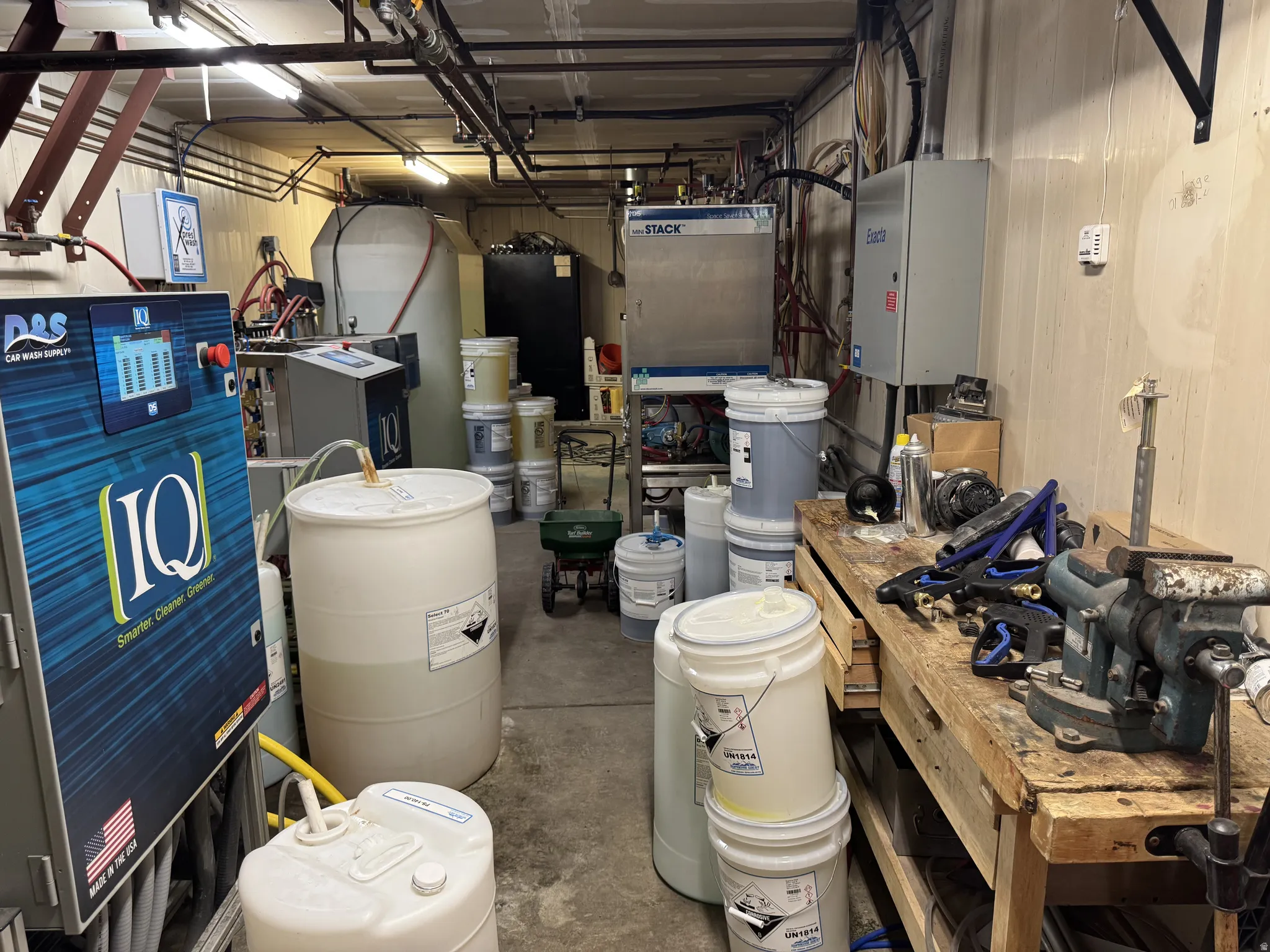 Garage with tankless water heater and a workshop area