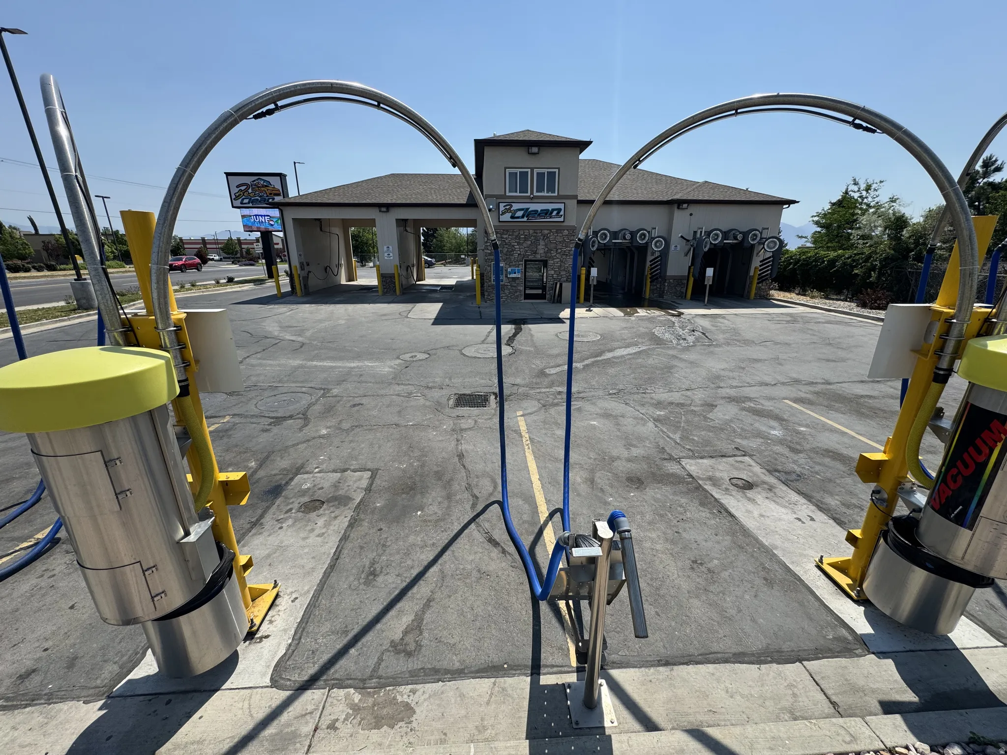 View of asphalt road featuring street lighting