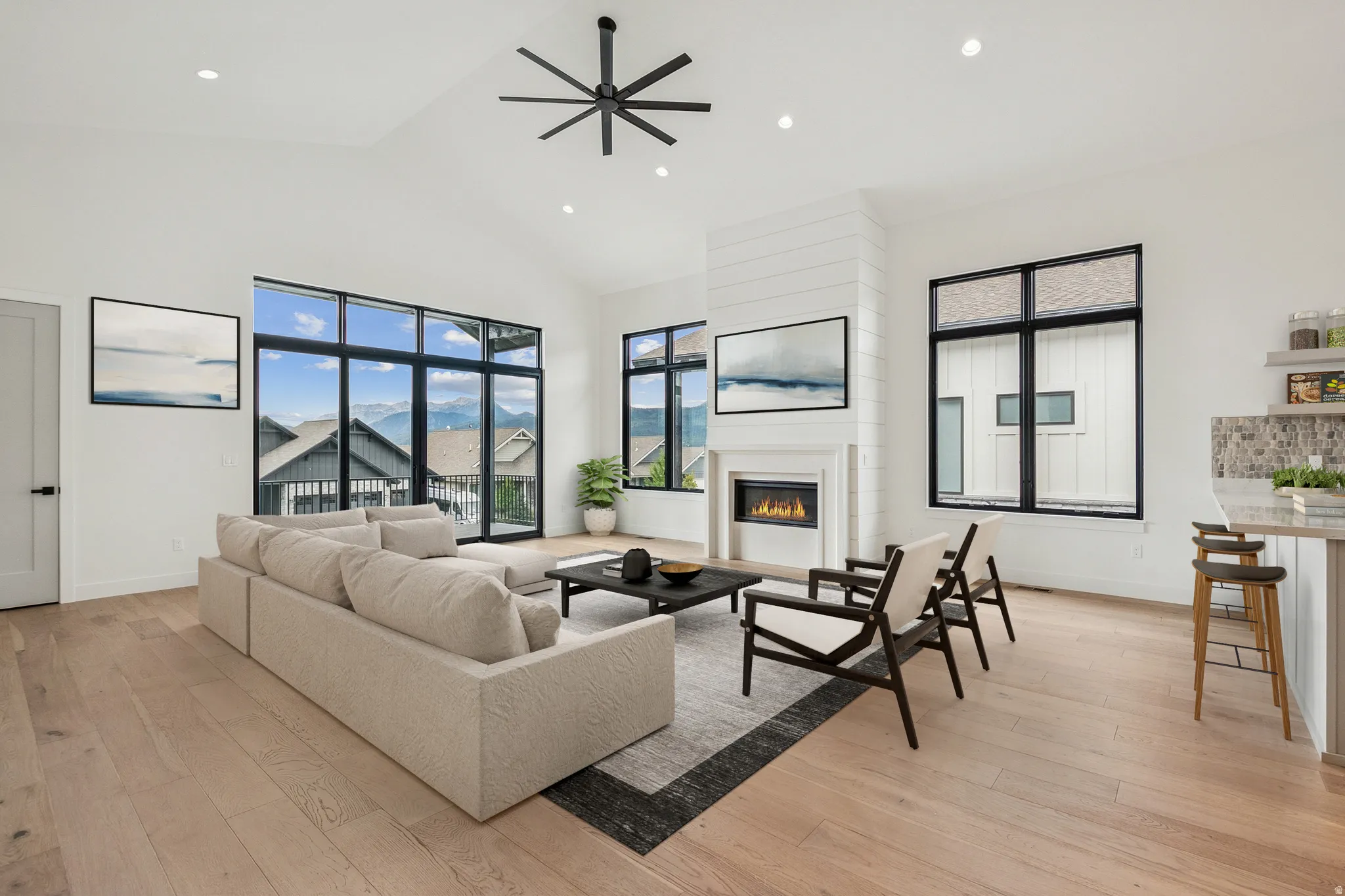 Upper level great room with large windows and sliding door to outside deck. (virtual staging)