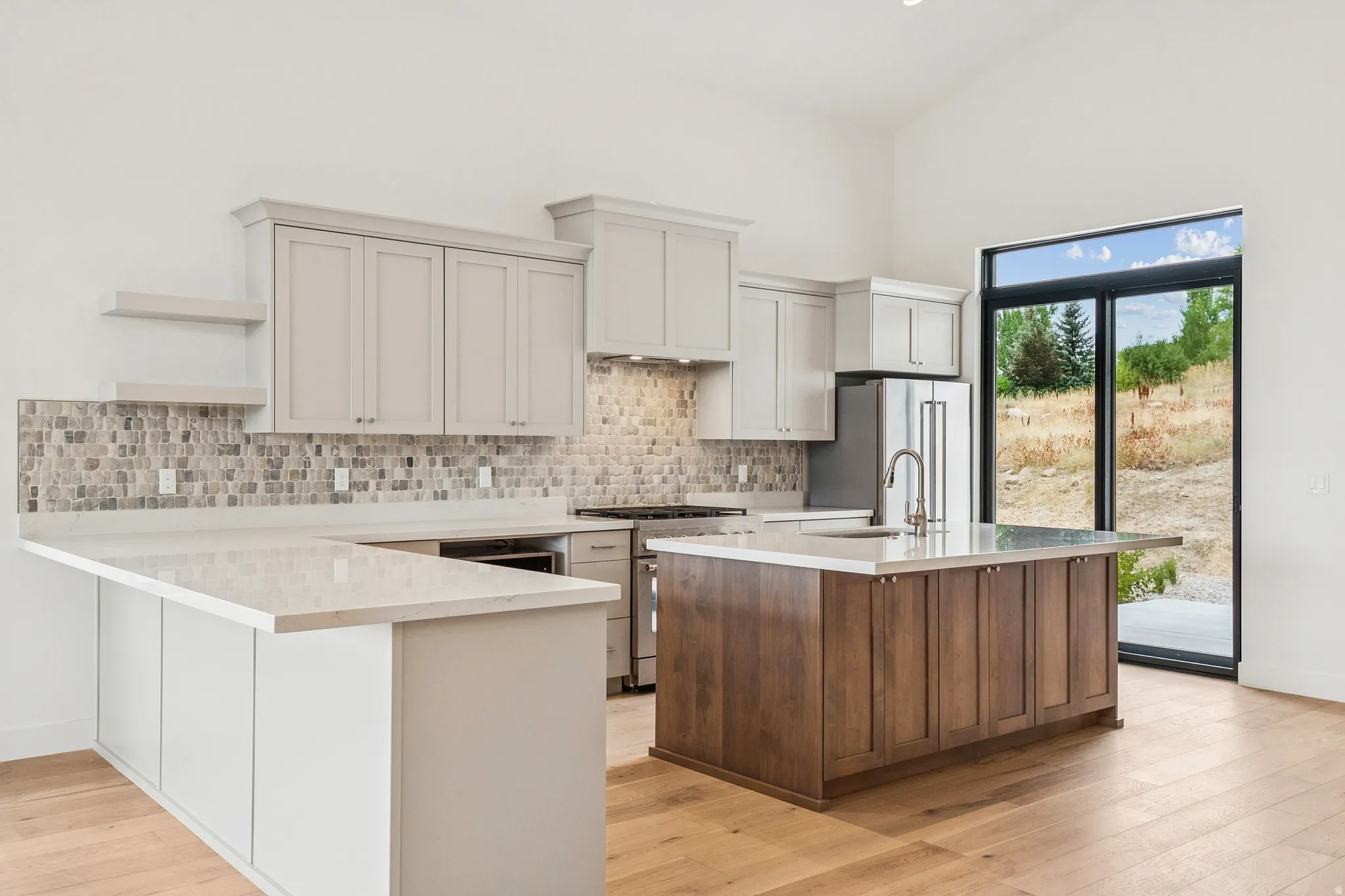 Well equiped Kitchenaid appliance package, including stainless steel fridge with plenty of seating at counter and island to see what's cooking.