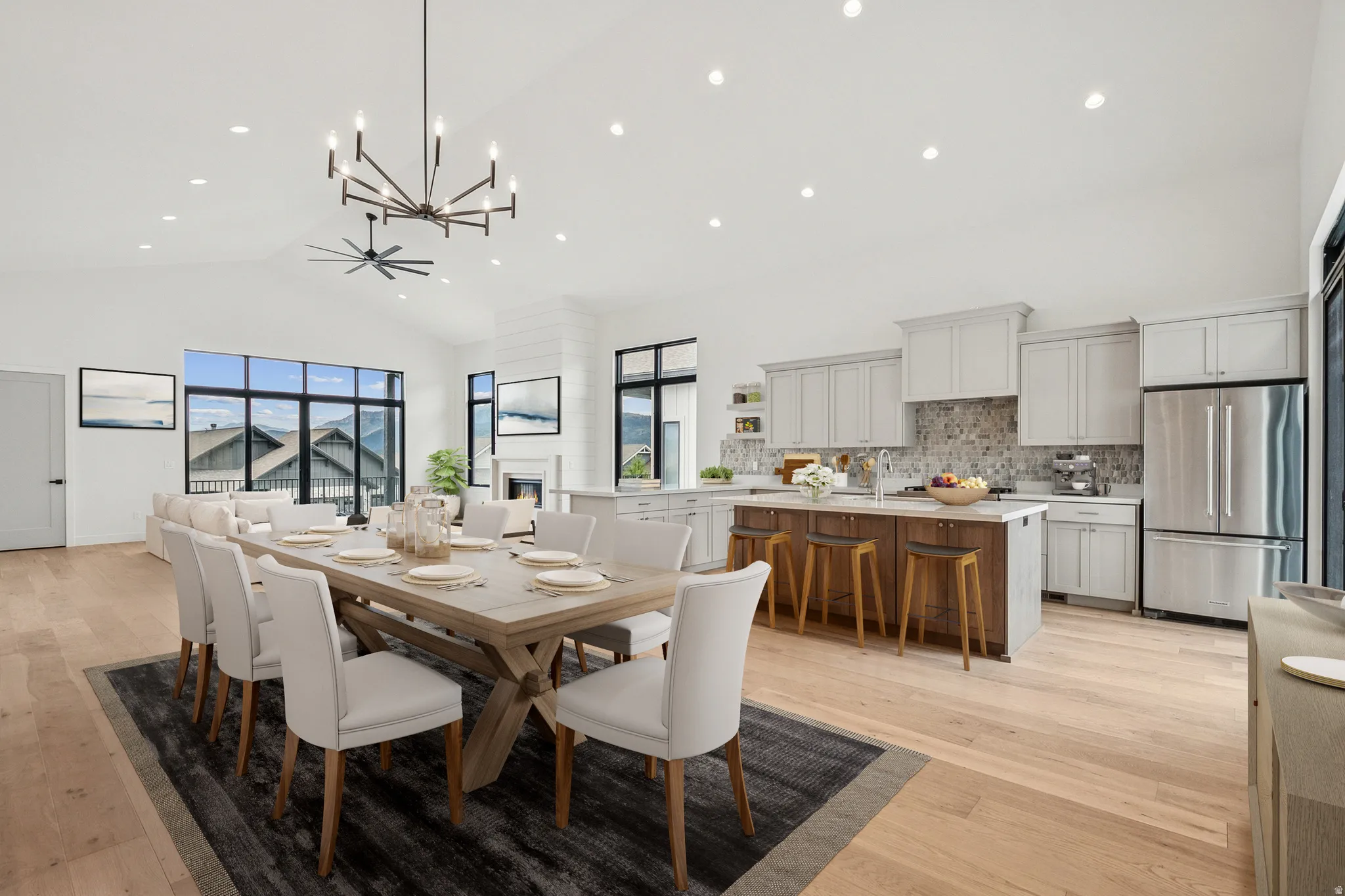 Spacious dining  area with high vaulted ceiling, chandelier, recessed lighting adjacent to kitchen area (virtual staging)