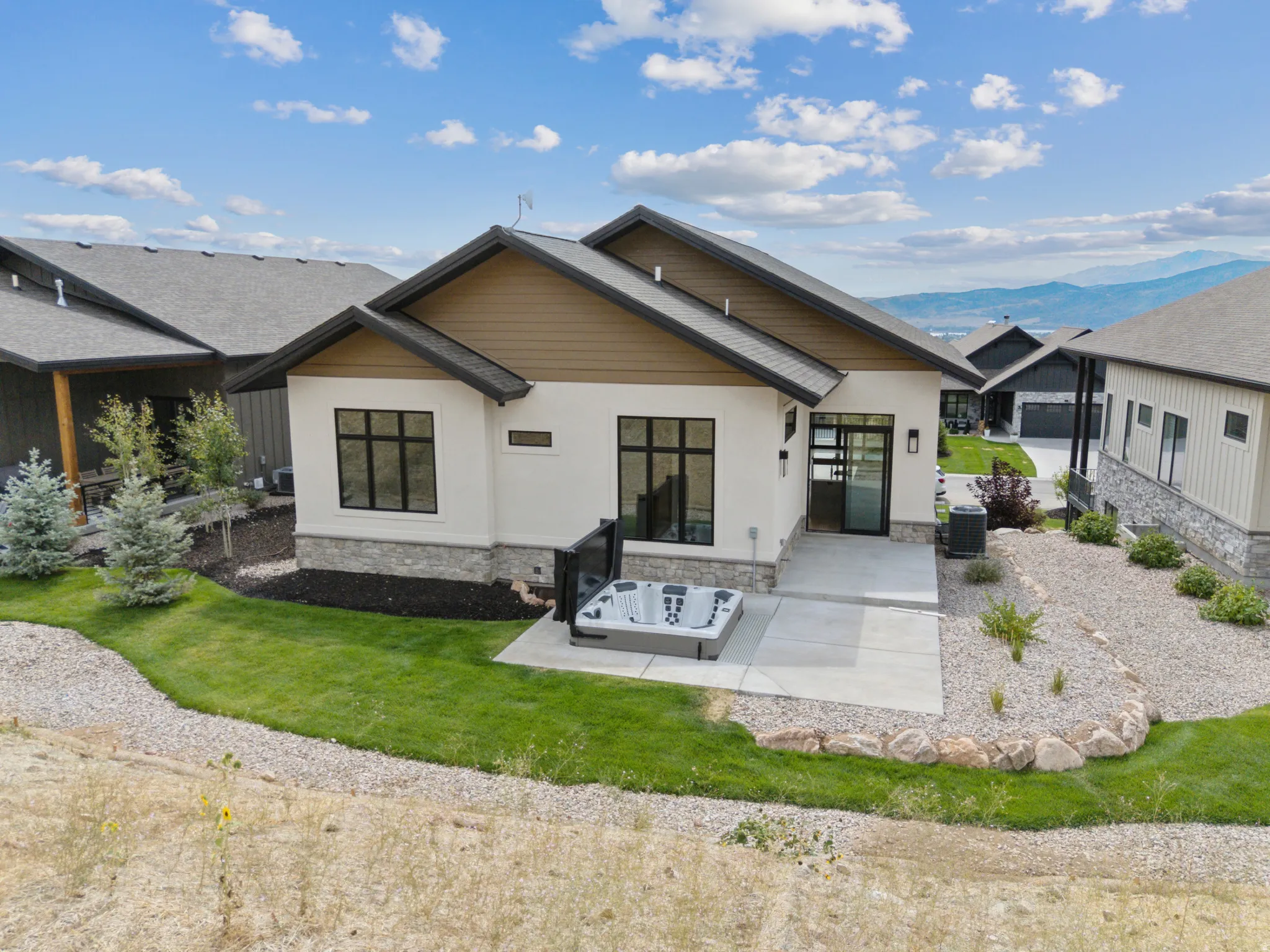 Back of property featuring a hot tub, gas line for BBQ and mountain view.