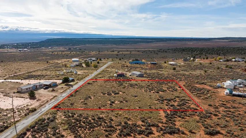 Aerial view of sparsely populated area featuring property parcel outlined and a desert landscape
